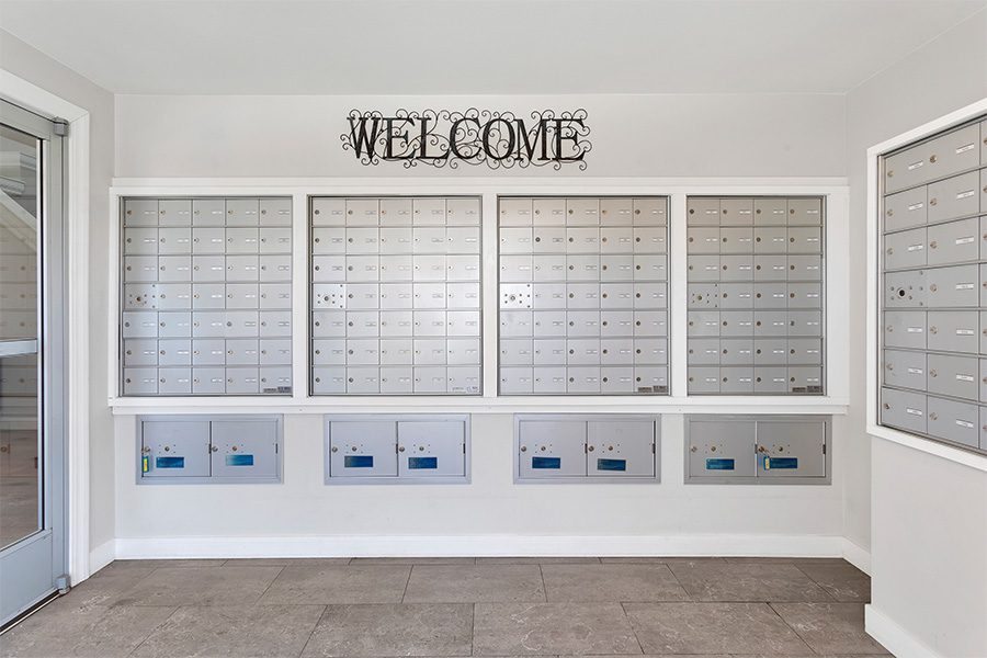 Mail room with tiled floor, mail boxes, and eclectic