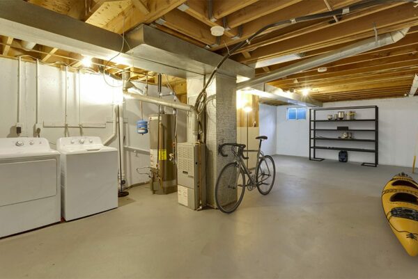 Unfinished basement with a washer & dryer.