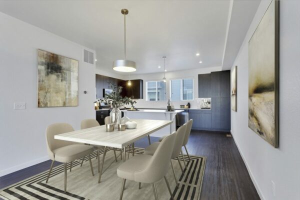 Rending of a open-concept dining room and kitchen with dark wood floors, dark cabinets, and white countertops.