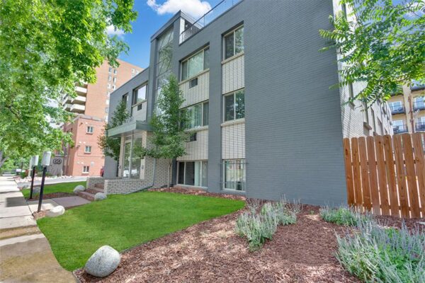 50 Corona apartments with grey brick construction, art deco styling, and rooftop patio.