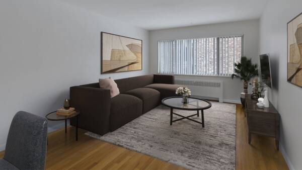 Living room with a carpet over wood floors, white walls, and a large window.