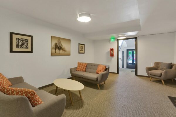 Lounge with plush couches and framed artwork.