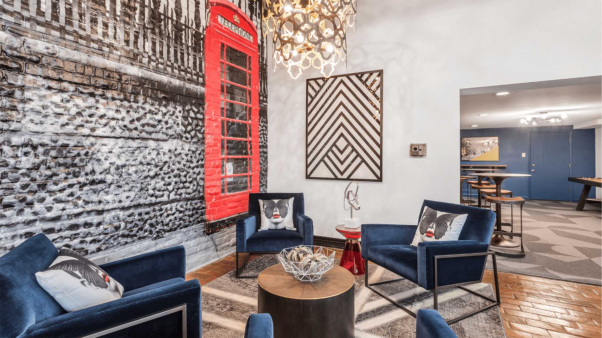 Apartment lobby with plush chairs and eclectic decor.