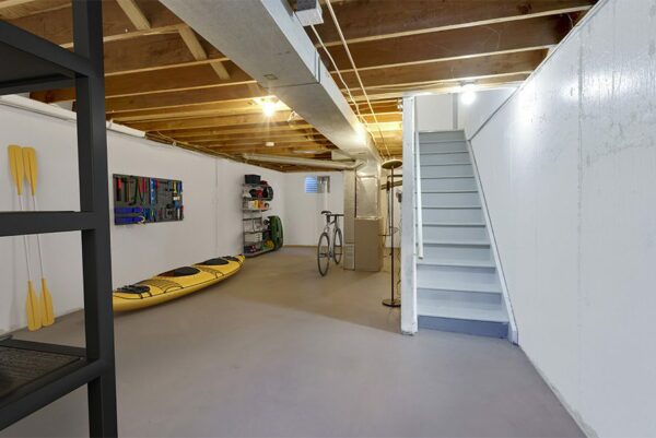Unfinished basement with storage areas.