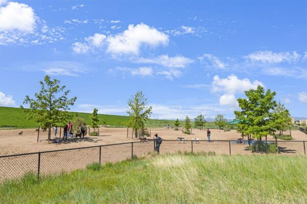 Dog park with trees and gazebos in Lowry neighborhood.