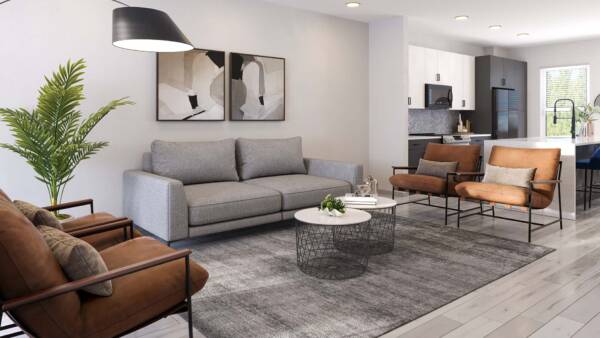 Living room with plush seating, framed artwork, large plant, and ceiling fan.
