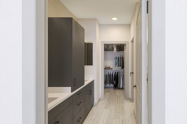 Bathroom with dark cabinets, light counters, and large framed mirrors.