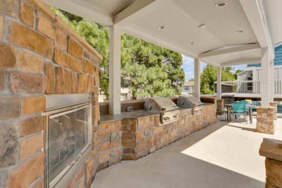 stone fire place with two outdoor grills