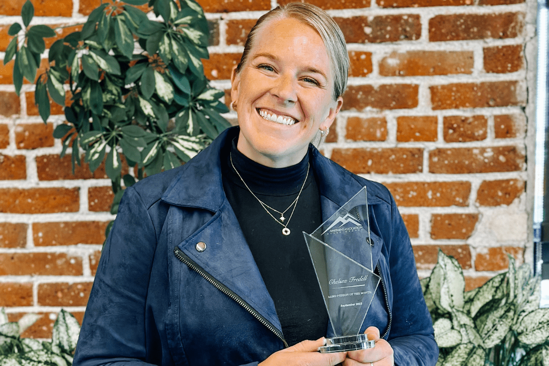 Chelsea Fredell holding her trophy after being names AAMD's person of the month of September