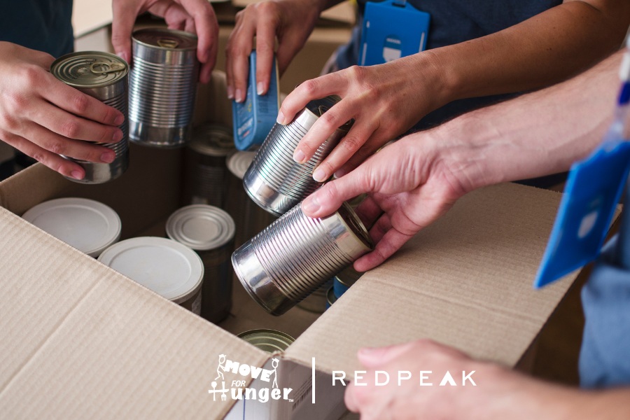 image of arms dropping cans into a box for a donation drive