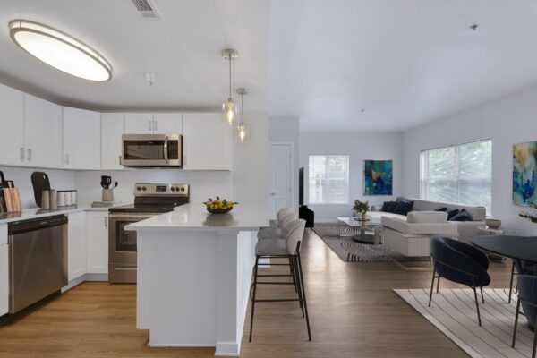 kitchen with white cabinets and stainless steele appliances with view of living room