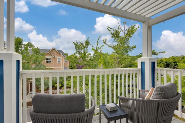 patio with blue exteriors and two lounge chairs