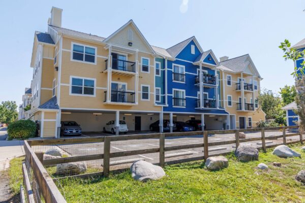 yellow and blue building with white trim and balconies