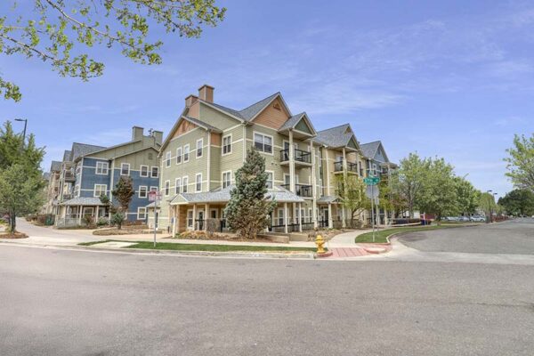 Trocadero apartments with colorful classic construction and tall trees.