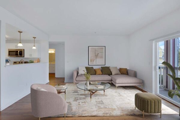 Trocadero apartment living room with rug, plush seating, modern furniture, and balcony door.