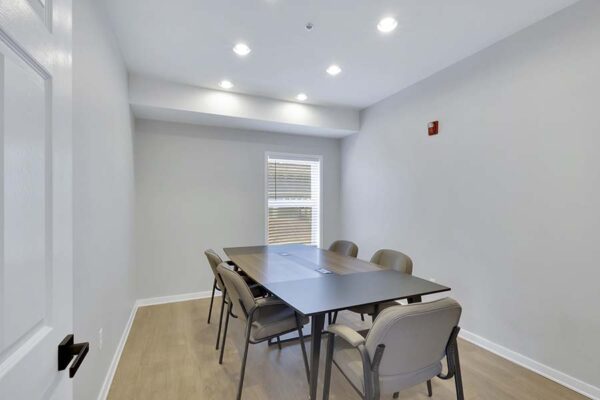 Trocadero apartments conference room with large table and chairs.