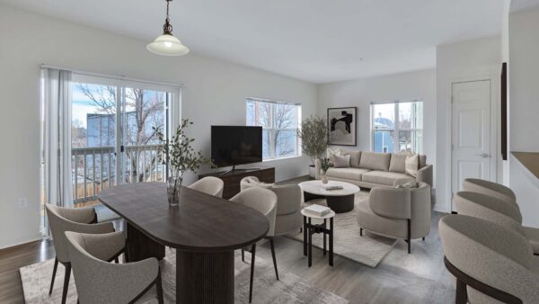 Trocadero apartment living room with plush seating, console with TV, dining table, and balcony door.