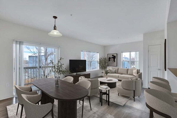 Trocadero apartment living room with plush seating, console with TV, dining table, and balcony door.