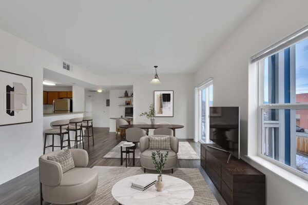 Trocadero apartment living room with plush seating, TV, large windows, and dining table.