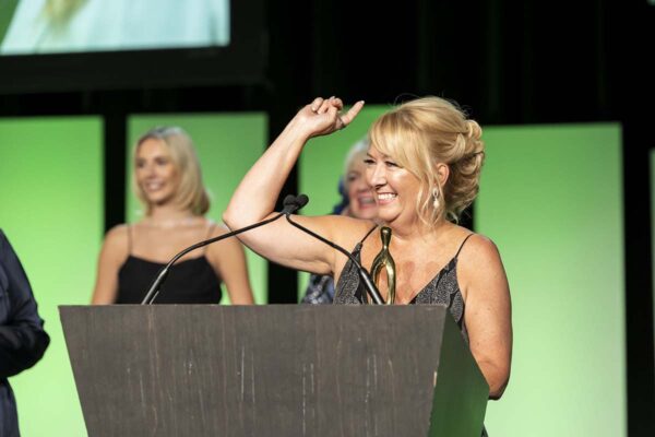 RedPeak employee speaking at award ceremony event.