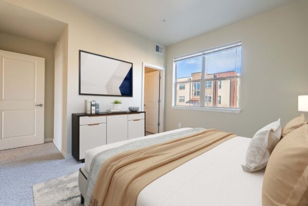 bedroom with dresser and large window