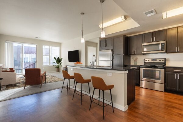 kitchen with kitchen island and orange bar stools