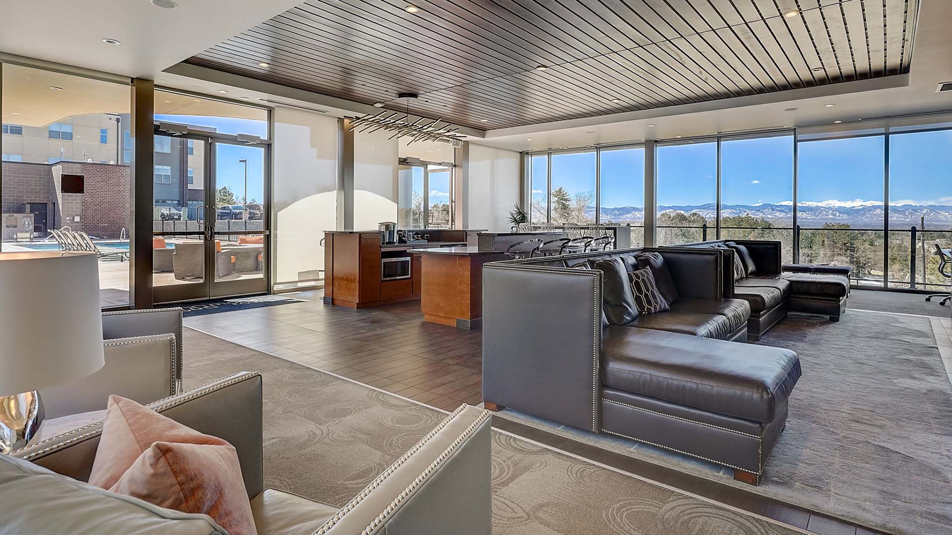 Monaco Row clubhouse with plush seating, large windows, and community kitchen.