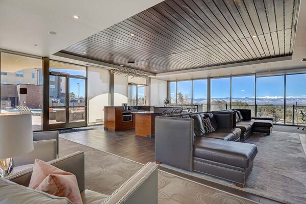 Monaco Row clubhouse with plush seating, large windows, and community kitchen.