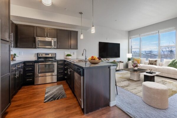 L shaped kitchen with dark walnut cabinets and large counter top