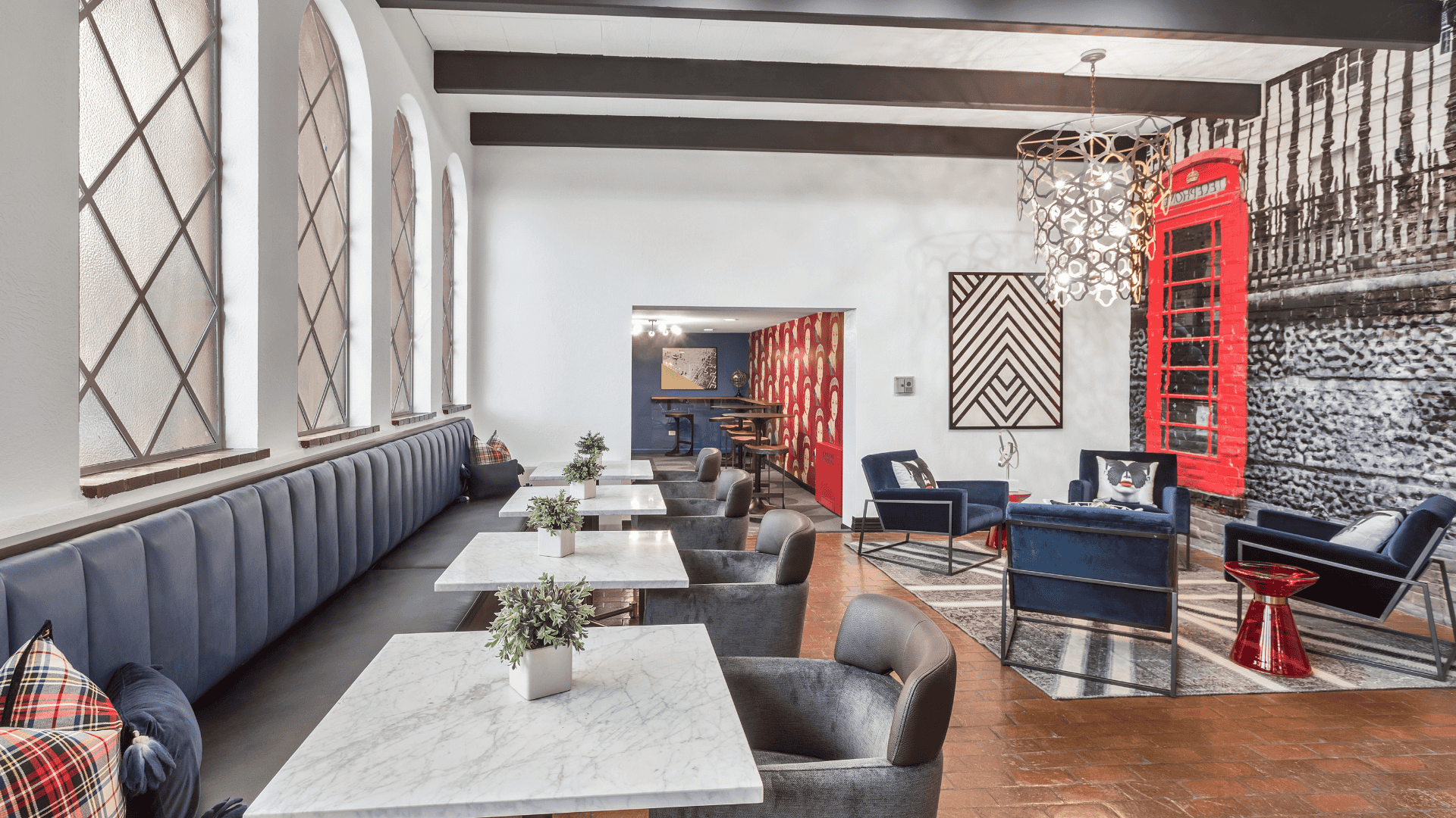 lobby entrance with blue chairs, brick wall, and chandelier