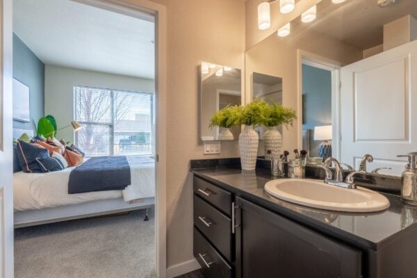 ensuite bathroom with large sink and view of bedroom