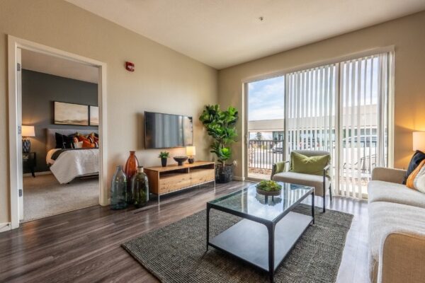 living room with couch, coffee table, and large sliding glass door