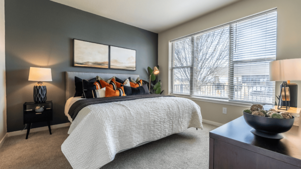 large bedroom with king sized bed and large window