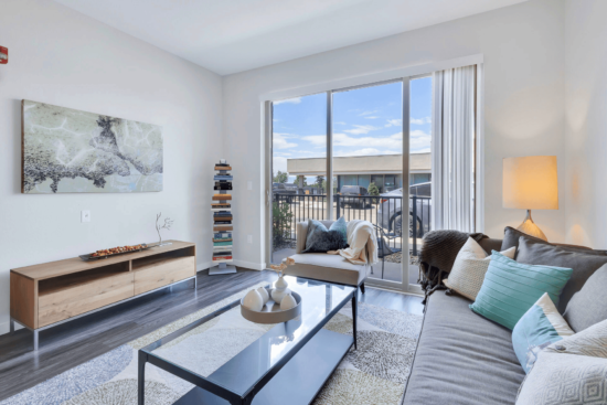 living room with couch and large sliding door to patio