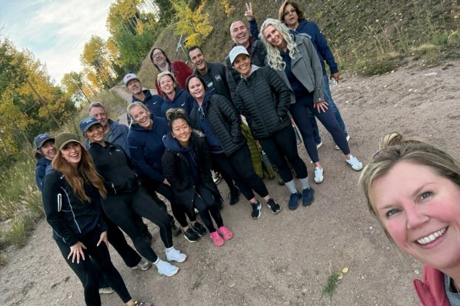 group of team members in the mountains posing for a group photo