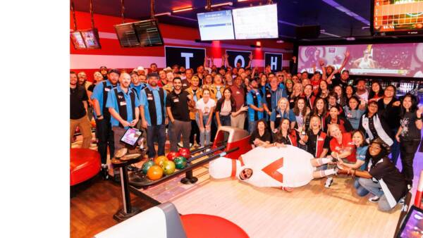 group of people posing at a bowling alley
