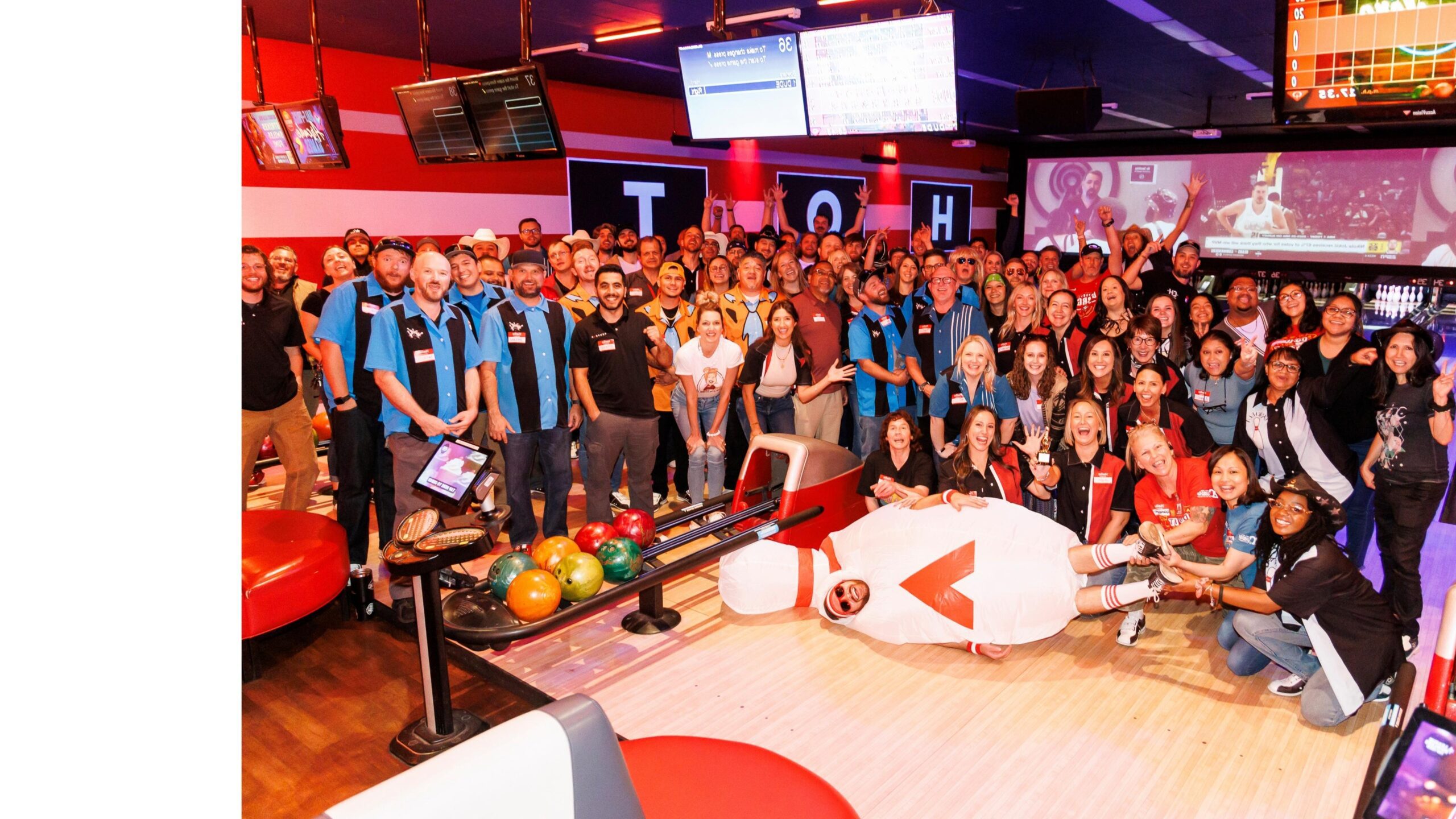 group of people posing at a bowling alley