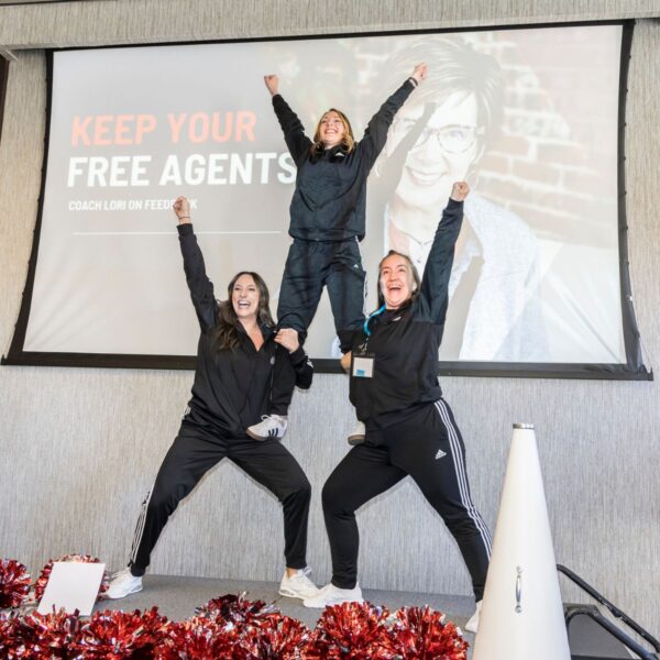 three girls cheering at conference