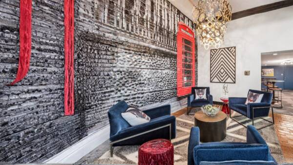 lobby setup with blue velvet chairs, london inspired designs, and a chandelier