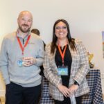 two team members smiling for photo