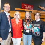 four team members smiling for photo