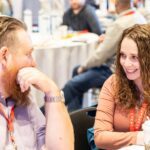 two team members smiling for photo