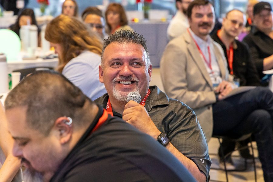 RedPeak team member at leadership conference speaking into microphone