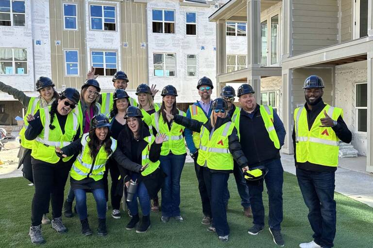RedPeak team posing together at a construction project.