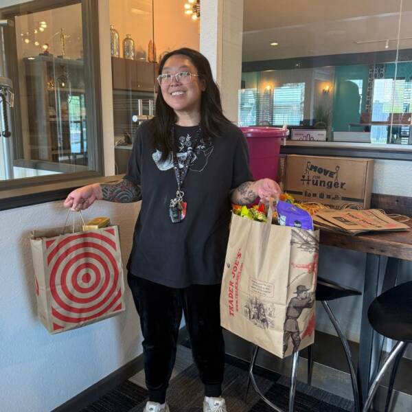 resident holding canned food donations at a move for hunger RedPeak event
