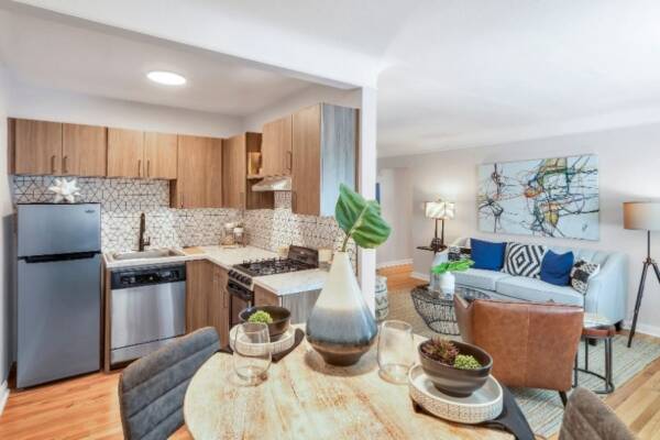 living room and kitchen view with couch, dining table, and fridge
