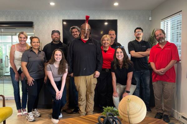team members gathered to celebrate winning award