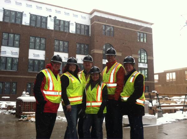six people standing in front of construction zone