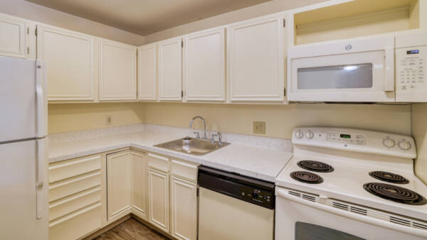 kitchen with white cabinets, countertops, and range stove