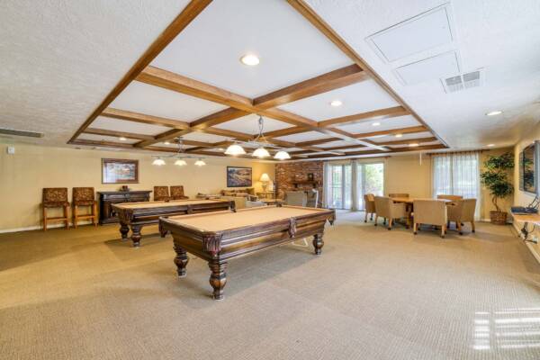 The Manchester community lounge with pool tables and plush seating.